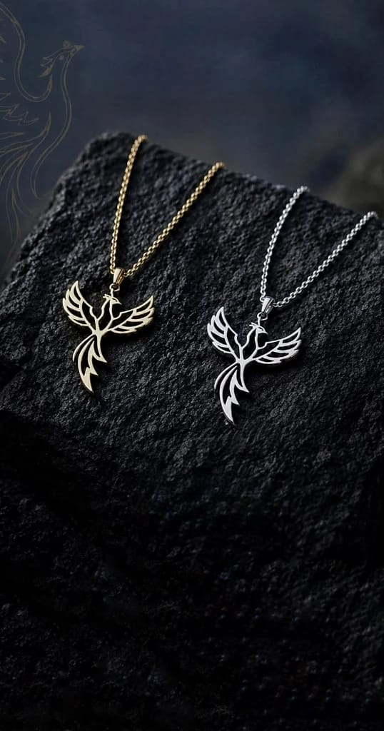Aaruké Ember Phoenix Necklace — gold and silver phoenix pendants on dark stone
